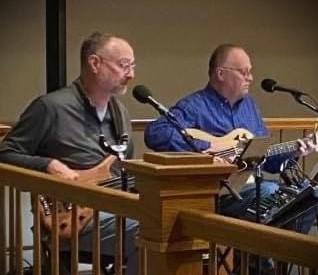 Photo of the 2 Molter Brothers playing instruments at the library